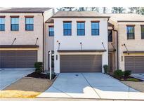 Well-maintained townhome exterior with garages and neat landscaping, offering a modern and inviting curb appeal at 1012 Rohner Way, Smyrna, GA 30080