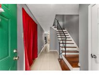 Inviting entryway with tiled flooring, a staircase, and a striking green front door at 2340 Beaver Ruin Rd # 68, Norcross, GA 30071