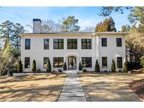Stunning two-story home featuring modern architecture, black-framed windows, and a beautifully landscaped front yard at 4132 Carmain Ne Dr, Atlanta, GA 30342