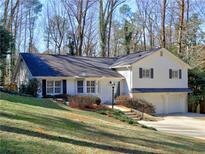 Charming two-story home with lush front yard and attached two-car garage at 5660 Colton Dr, Atlanta, GA 30342