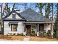 Charming bungalow with a covered front porch and well-maintained landscaping at 1171 Eggleston Sw St, Atlanta, GA 30310