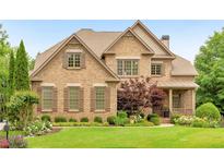 Stunning two-story brick home with manicured lawn and mature landscaping, offering timeless elegance and curb appeal at 2953 Kings Walk Ave, Marietta, GA 30062
