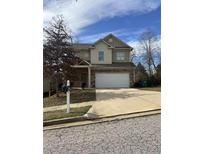 Charming two-story home featuring a two car garage and welcoming front yard at 4373 Trake Way, Ellenwood, GA 30294