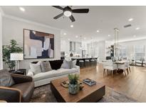Bright living room featuring modern decor, a ceiling fan, and an open floor plan at 425 Burton Dr, Alpharetta, GA 30009