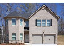 Charming two-story home with a two-car garage, a front door, and a beautiful brick exterior at 637 Egrets Landing #51, Covington, GA 30014