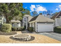 Beautiful home with a well-manicured front yard and two-car garage at 305 Brassy Ct, Alpharetta, GA 30022