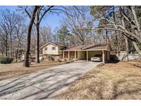 Charming split-level home featuring a covered carport and a long driveway at 3752 Chattahoochee Dr, Douglasville, GA 30135