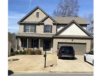 Charming two-story brick home with a well-manicured lawn and attached two-car garage at 526 Blue Mountain Rise, Canton, GA 30114