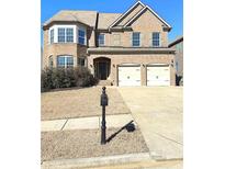 Charming brick two-story home with a well-maintained front yard and two-car garage at 615 Ceremony Way, Acworth, GA 30102