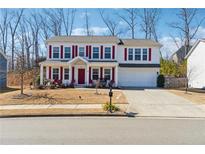 Charming two-story home with red shutters, a well-manicured lawn, and a double garage at 236 Augusta Walk, Canton, GA 30114