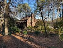 Charming house nestled in a wooded lot with mature trees and a well-maintained yard at 3121 Bonds Lake Nw Rd, Conyers, GA 30012