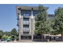 Contemporary condo building with brick accents, balconies, and well-maintained landscaping against a clear blue sky at 5300 Peachtree Rd # 2604, Atlanta, GA 30341