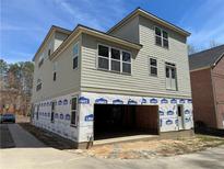 New construction home with gray siding, a two car garage, and modern windows at 2585 Governors Walk Blvd, Snellville, GA 30078