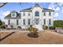 Beautiful two-story home featuring an elegant white facade and well-manicured landscaping at 1410 Barnsley Walk, Snellville, GA 30078