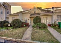 Charming townhome exterior with manicured bushes and inviting walkway at 5863 Trent Walk Dr, Lithonia, GA 30038