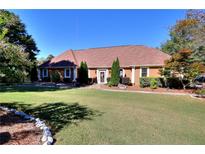 Charming single-story home with a well-manicured lawn and inviting entrance at 3889 Pineybrook Dr, Loganville, GA 30052