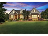 Charming brick home with a landscaped front yard and a welcoming entrance at 102 Glenmill Way, Woodstock, GA 30188