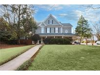 Charming two-story home featuring a beautifully landscaped yard and a welcoming front porch at 350 Lockwood Terrace, Decatur, GA 30030