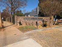 Brick entrance to The Decatur Townhouses with decorative landscaping and signage at 307 Adair St # 7-E, Decatur, GA 30030