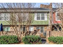 Charming multi-colored townhome featuring brick base, tidy landscaping, and a private front entrance at 307 Adair St # 7-E, Decatur, GA 30030