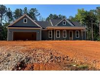 New home with a large garage and expansive front yard in a serene, wooded setting at 554 Presley Farm Pkwy, Rockmart, GA 30153