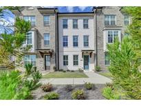 Charming townhome with a well manicured lawn, brick facade, and inviting entrance at 4320 Sims Park Overlook, Suwanee, GA 30024