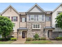 Charming townhome featuring a blend of brick and stone with stylish shutter accents at 549 Henry Dr, Marietta, GA 30064