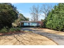 Charming single story home with well-maintained lawn and lush, mature landscaping creating private setting at 1976 Northside Nw Dr, Atlanta, GA 30318
