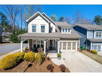 Charming two-story home with a welcoming front porch and a well-manicured landscaped yard at 2434 Soft Maple St, Atlanta, GA 30360