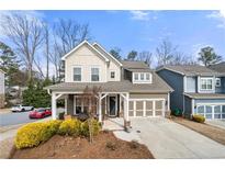 Charming two-story home featuring a welcoming front porch, well-maintained landscaping, and an attached two-car garage at 2434 Soft Maple St, Atlanta, GA 30360