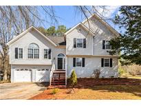 Charming two-story home featuring a two-car garage, arched entry, and manicured front yard at 13 Greystone Nw Ln, Cartersville, GA 30121