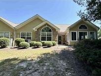 Charming single story home with a manicured front yard and lovely stone accents at 2191 Rockbridge Road, Stone Mountain, GA 30087
