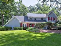 Charming two-story home with manicured lawn and well-maintained landscaping at 7440 Princeton Trce, Sandy Springs, GA 30328