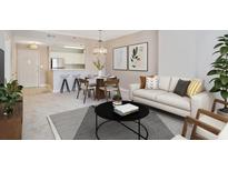 Bright living room featuring a dining area with a chandelier and a modern sofa with decorative pillows at 1101 Juniper Ne St # 722, Atlanta, GA 30309