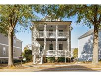 Charming two-story home boasts double porches, adding unique curb appeal and outdoor living space at 1658 Duncan Nw Dr, Atlanta, GA 30318