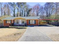 Charming single-story brick home with a covered carport and long driveway at 3701 W County Line Rd, Douglasville, GA 30135