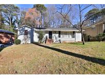 Charming single-story home featuring a well-maintained lawn, classic brick facade, and inviting front entrance at 3532 Dial Dr, Stone Mountain, GA 30083