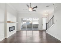 Bright living room featuring a ceiling fan, modern fireplace, and sliding glass doors to a patio at 671 Stickley Oak Way, Woodstock, GA 30189