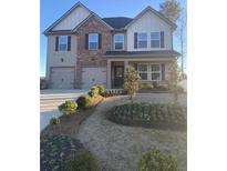 Two-story home featuring a symmetrical design with a brick and siding exterior, complemented by well-maintained landscaping at 736 Great Oak Pl, Villa Rica, GA 30180