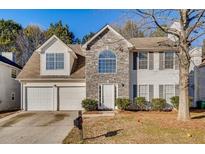Charming two-story home featuring a stone facade, attached two-car garage, and well-maintained landscaping at 2921 Russ Ln, Lithonia, GA 30058