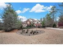 Stately brick home boasts meticulous landscaping and a circular driveway at 3647 Little Spg, Stockbridge, GA 30281