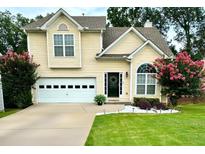 Charming two-story home with a well-maintained lawn, lovely landscaping, and an attached two-car garage at 4146 Mcever Park Dr, Acworth, GA 30101