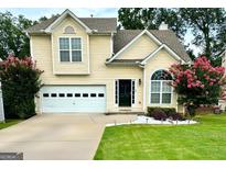 Charming two-story home with a well-maintained lawn, attached garage, and mature landscaping at 4146 Mcever Park Dr, Acworth, GA 30101