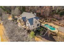 Beautiful aerial shot of the home showcasing the backyard swimming pool, manicured grounds, and stunning architectural design at 4755 Columns Se Dr, Marietta, GA 30067