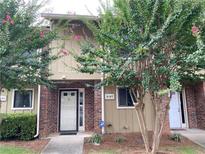 Charming townhouse exterior featuring brick accents, mature trees, and well-maintained landscaping at 2147 Palmyra Se Dr, Marietta, GA 30067