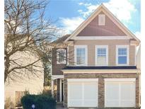 Charming two-story home with a stone facade and attached two-car garage at 922 Gardenia Curv, Canton, GA 30114