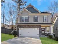 Charming two-story home features a stone-accented facade, two-car garage, and well-manicured lawn at 132 Cessna Dr, Canton, GA 30114