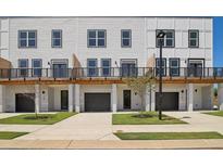 New townhouse with white siding, black trim, garages, and landscaping at 1092 Glen Opal Dr, Decatur, GA 30032
