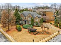 Charming two-story brick home featuring manicured landscaping and mature trees, perfect for suburban living at 2310 Gracehaven Way, Lawrenceville, GA 30043