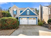 Charming home with a blue exterior, white trim, and a two-car garage, complemented by a well-manicured lawn at 240 Leasingworth Way, Roswell, GA 30075